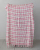 boucle throw blanket in a pink plaid pattern