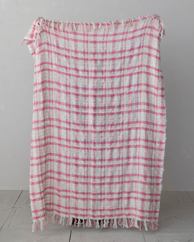 boucle throw blanket in a pink plaid pattern