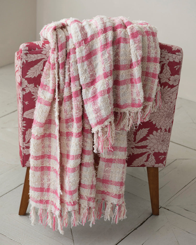 boucle throw blanket in a pink plaid pattern