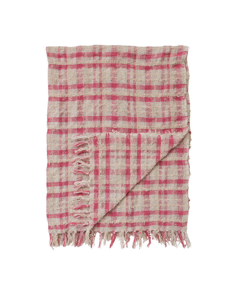 boucle throw blanket in a pink plaid pattern