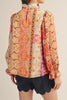 lightweight blouse with a colorful mixed print design in shades of orange, red, pink, and yellow