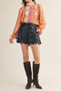 lightweight blouse with a colorful mixed print design in shades of orange, red, pink, and yellow
