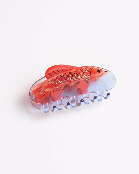 clear blue hair claw with a red bejeweled fish design