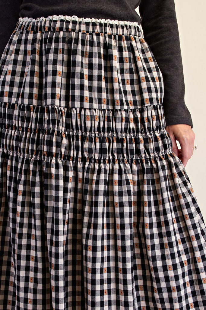 black and white plaid maxi skirt with smocked details and white lace trim. 