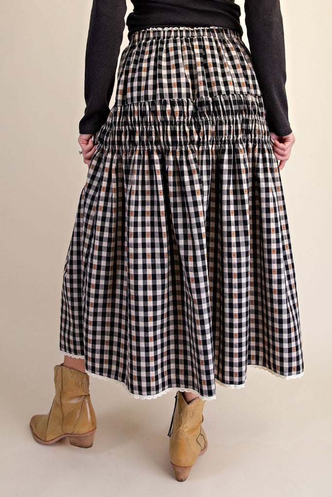 black and white plaid maxi skirt with smocked details and white lace trim. 