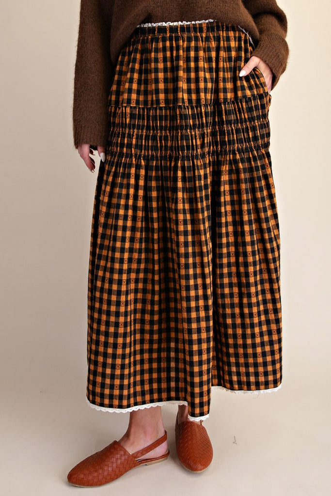 brown and black plaid maxi skirt with smocked details and lace trim