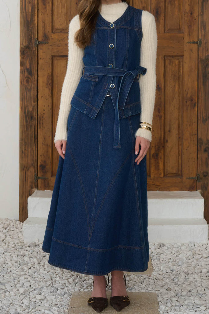 fitted vest with adjustable belt in a dark blue denim wash 