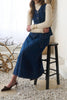 fitted vest with adjustable belt in a dark blue denim wash 
