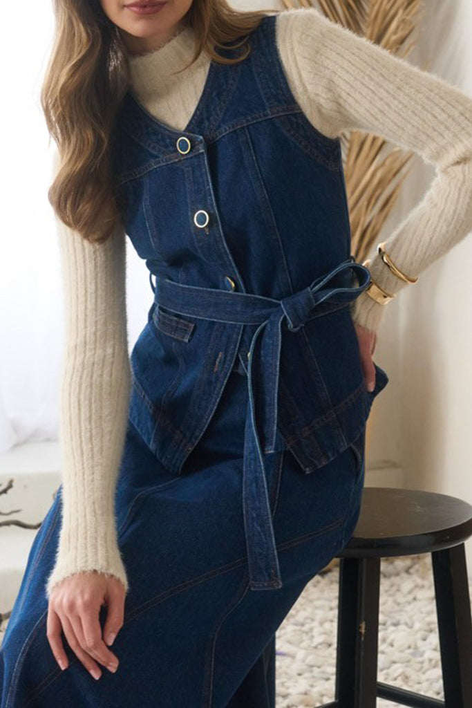 fitted vest with adjustable belt in a dark blue denim wash 