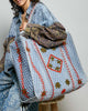 oversized quilted tote bag in faded denim blue with embroidered details in red and green