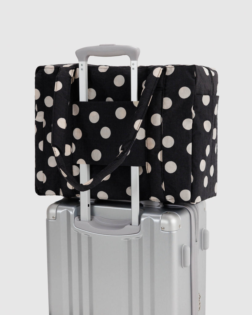 small cloud carry-on bag in black and cream polka dot from baggu