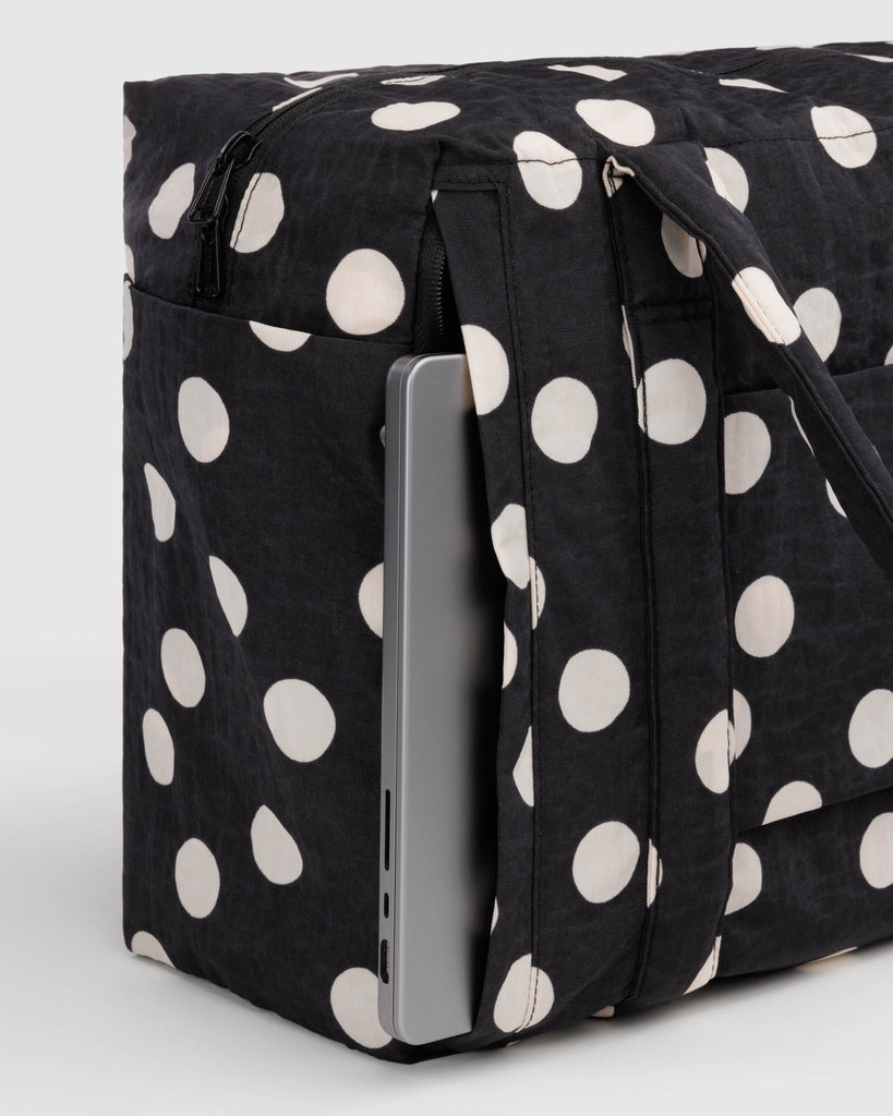 small cloud carry-on bag in black and cream polka dot from baggu