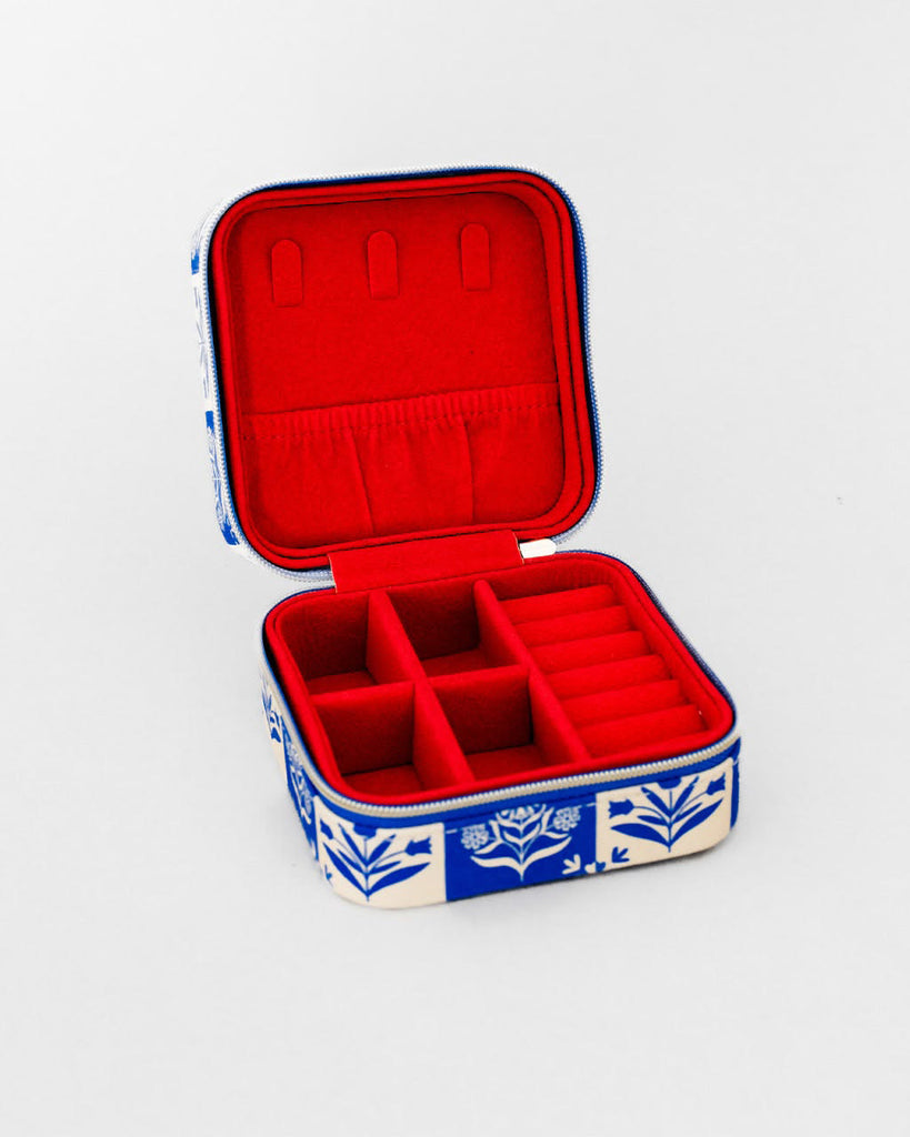travel jewelry organizer in a blue plaid floral pattern and red faux suede lining