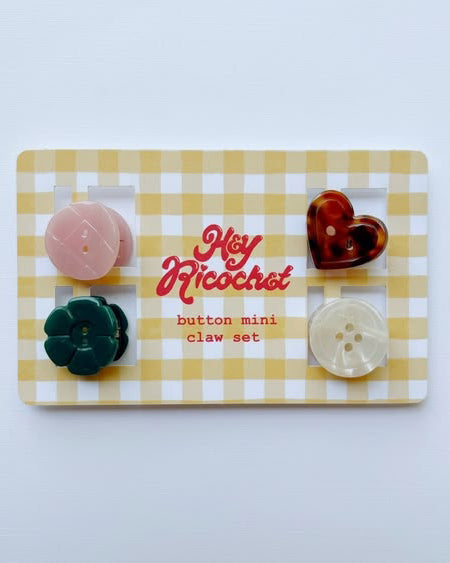 set of mini hair claws with a button-inspired design
