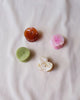 set of mini hair claws with a button-inspired design