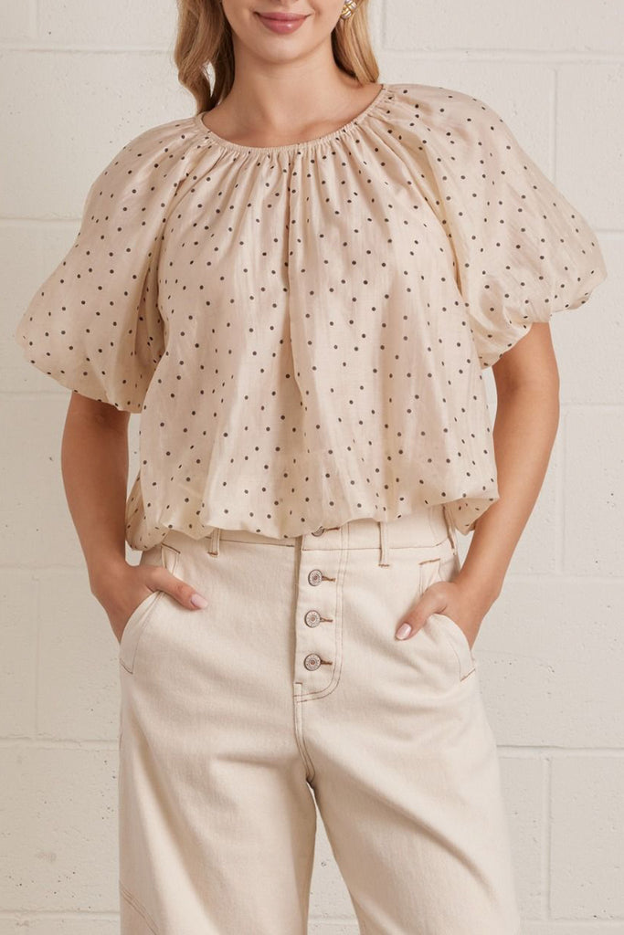 lightweight short sleeve top in shimmery ecru with petite black polka dots throughout.