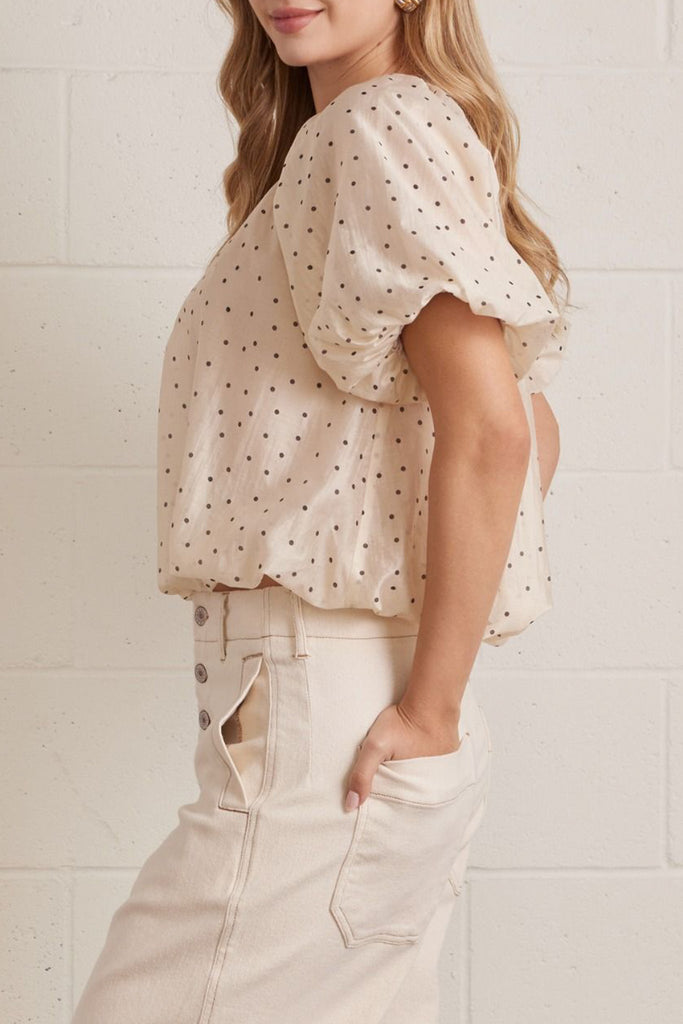 lightweight short sleeve top in shimmery ecru with petite black polka dots throughout.