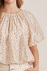 lightweight short sleeve top in shimmery ecru with petite black polka dots throughout.