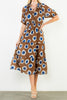 striking midi dress in a bold brown, blue, and white floral pattern