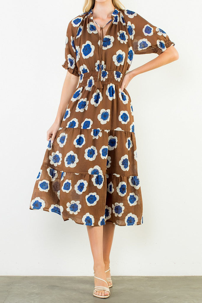 striking midi dress in a bold brown, blue, and white floral pattern