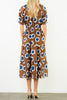 striking midi dress in a bold brown, blue, and white floral pattern