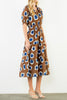 striking midi dress in a bold brown, blue, and white floral pattern