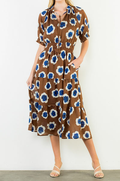 striking midi dress in a bold brown, blue, and white floral pattern