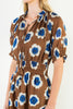 striking midi dress in a bold brown, blue, and white floral pattern