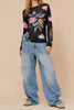 sheer mesh long sleeve top in black with a colorful celestial design