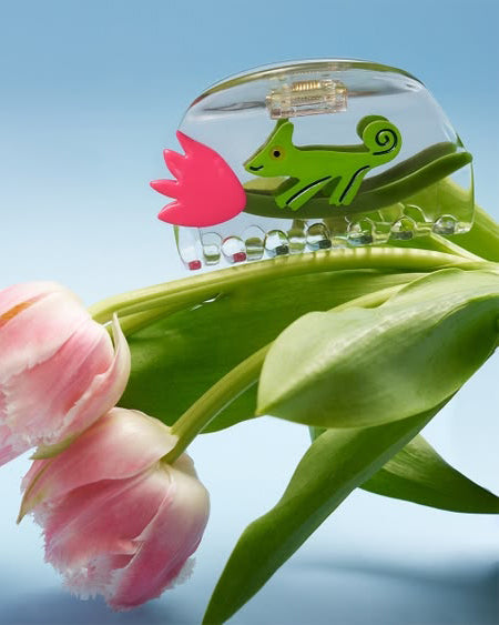 clear acetate hair claw with a green chameleon holding on to a pink tulip
