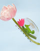 clear acetate hair claw with a green chameleon holding on to a pink tulip