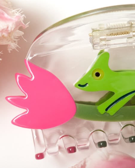 clear acetate hair claw with a green chameleon holding on to a pink tulip