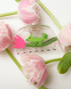 clear acetate hair claw with a green chameleon holding on to a pink tulip