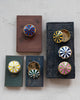 small storage boxes in the shape of a striped circus tent