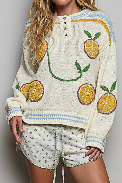 roomy chenille henley-style pullover with orange slice applique details on front.