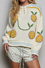 roomy chenille henley-style pullover with orange slice applique details on front.
