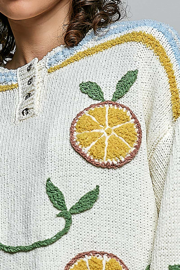 roomy chenille henley-style pullover with orange slice applique details on front.
