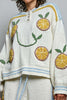 roomy chenille henley-style pullover with orange slice applique details on front.