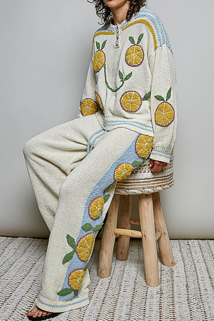 roomy chenille henley-style pullover with orange slice applique details on front.