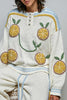 roomy chenille henley-style pullover with orange slice applique details on front.
