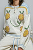 roomy chenille henley-style pullover with orange slice applique details on front.