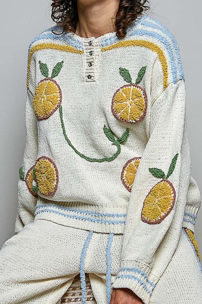roomy chenille henley-style pullover with orange slice applique details on front.
