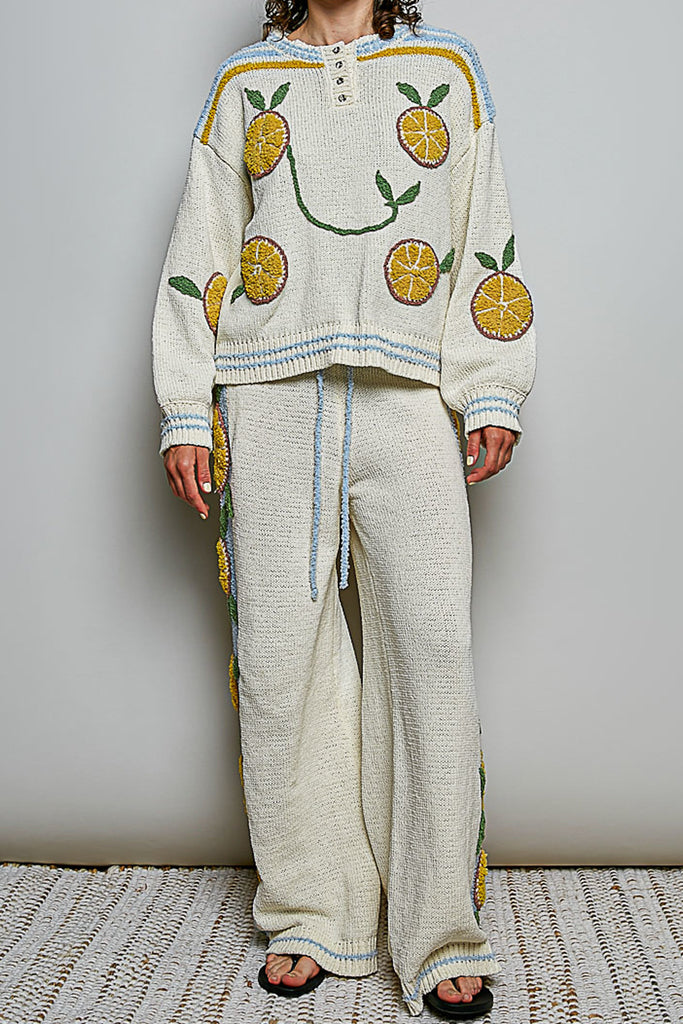 roomy chenille henley-style pullover with orange slice applique details on front.