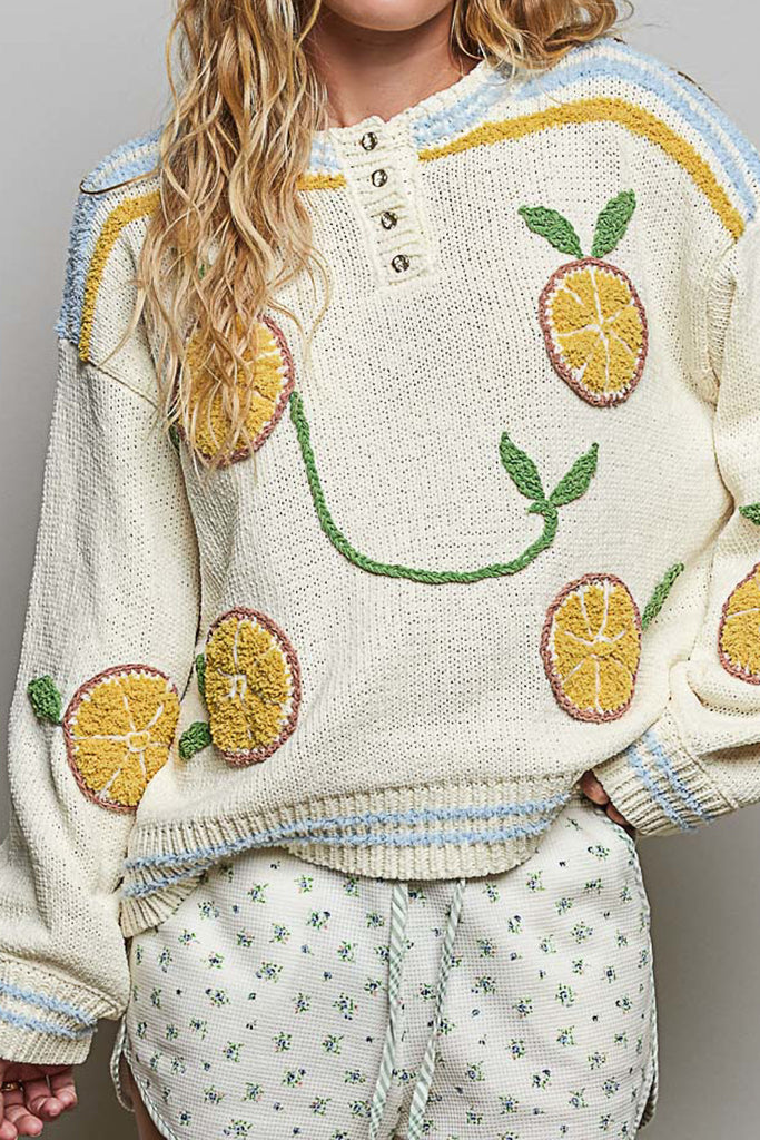 roomy chenille henley-style pullover with orange slice applique details on front.