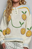roomy chenille henley-style pullover with orange slice applique details on front.
