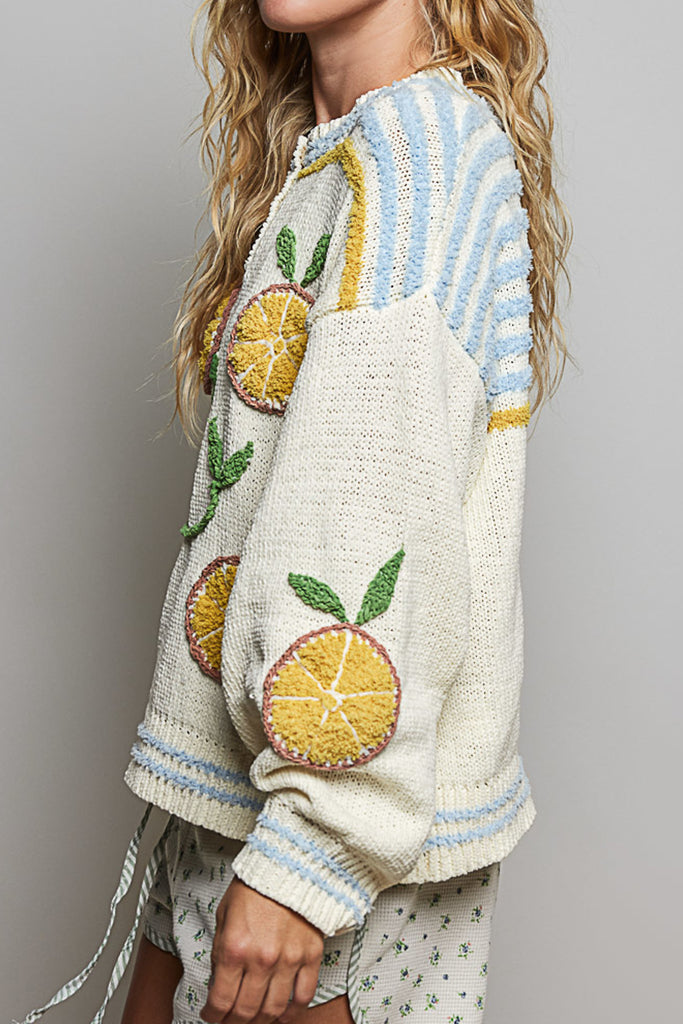 roomy chenille henley-style pullover with orange slice applique details on front.