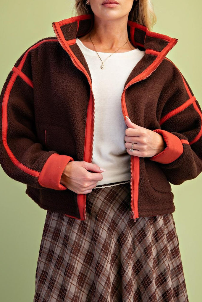 chocolate brown fleece jacket with bold red contrast trim