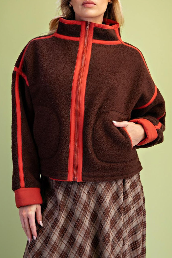 chocolate brown fleece jacket with bold red contrast trim