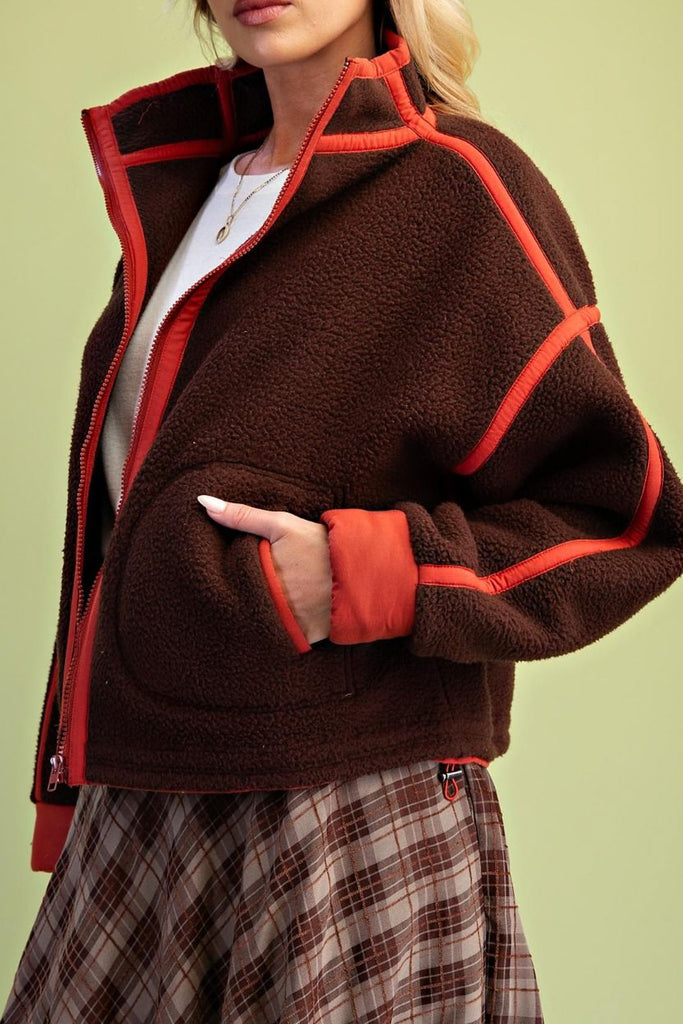 chocolate brown fleece jacket with bold red contrast trim