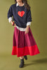a-line midi skirt with a color blocked design in poppy red and burgundy